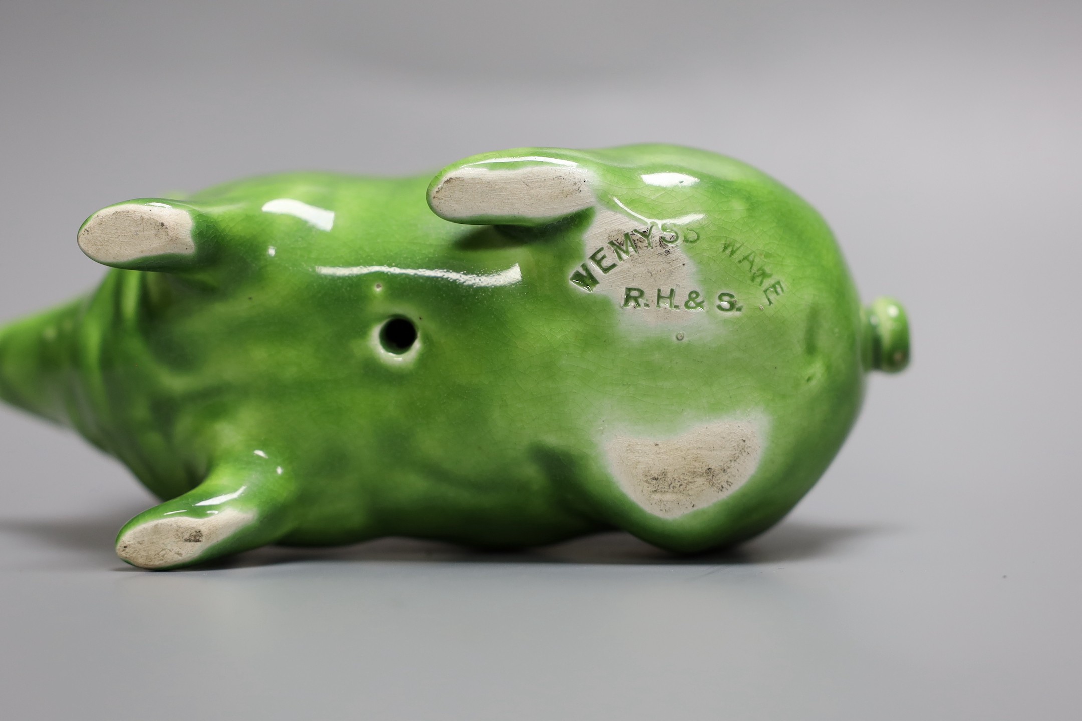 A Wemyss ware pig, decorated in lime green glaze and impressed to the base Wemyss ware RH & S, for Robert Heron & Son of Fife, 16.5cm long, 10cm high.